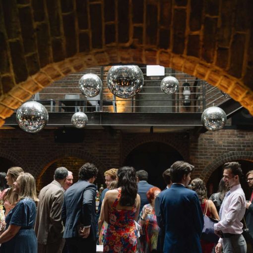 Guests under multiple mirror balls in the main reception room at The Foundry. Guests under multiple mirror balls in the main reception room at The Foundry.
